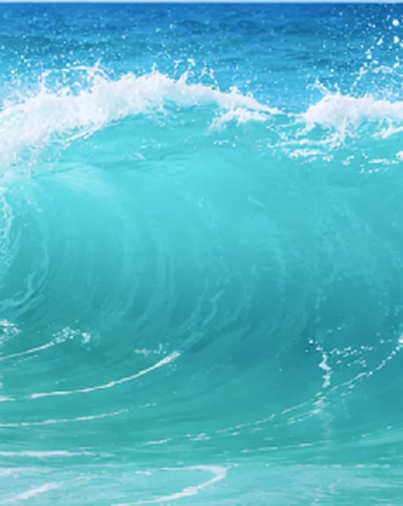 Deep blue wave curling over in open water